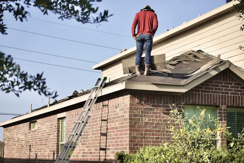 Professional roofer working on a residential roof in Mishawaka